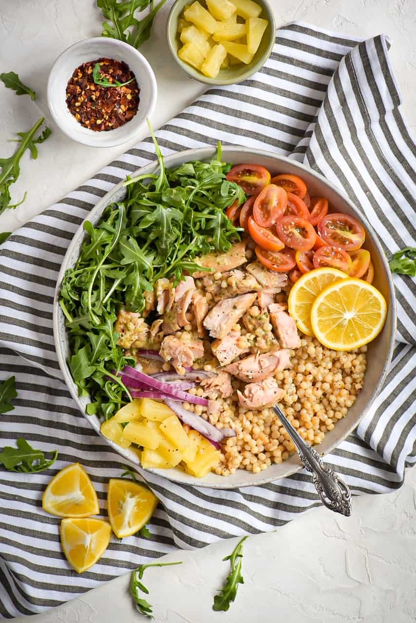 baked roasted garlic and butter salmon with couscous tropical bowl